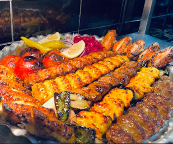 : Soofi restaurant large silver platter of mixed Persian kebabs: Koobideh, chicken, wings, and sides.